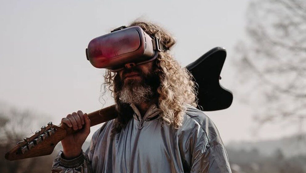 Virtual reality headset and electric guitar in an outdoor scene, representing innovative entertainment and music experiences.