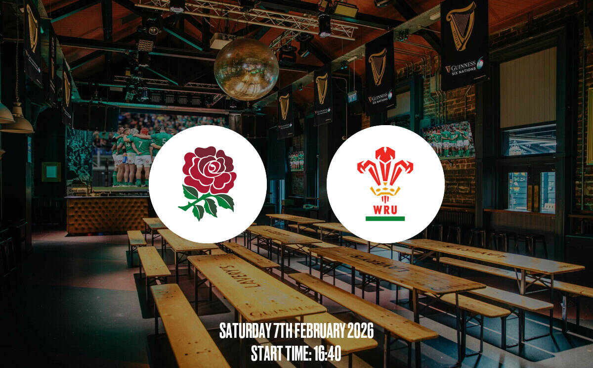 A lively Irish pub hosting a rugby match with Wales and Wales Rugby Union logos, inside a decorated sports bar with multiple screens, wooden benches, and a warm, inviting atmosphere.