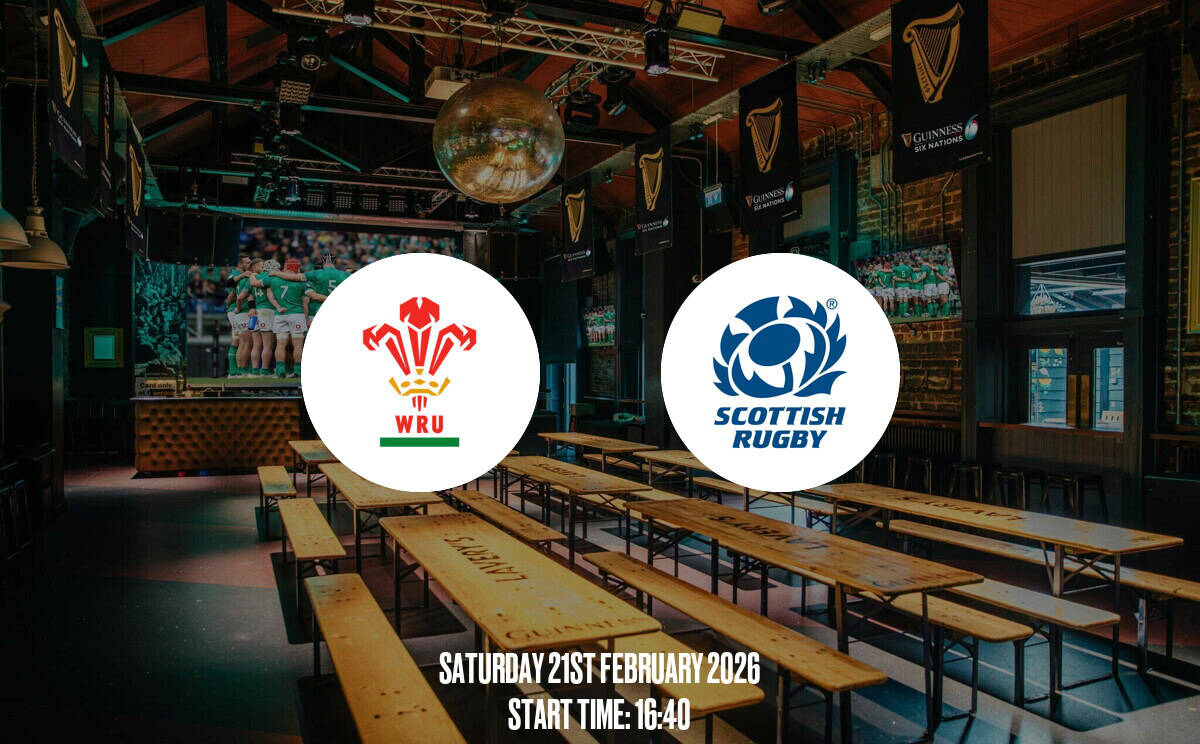An indoor sports bar decorated with rugby banners, TVs showing a rugby game, and wooden benches, ideal for rugby fans to watch WRU and Scottish Rugby matches.