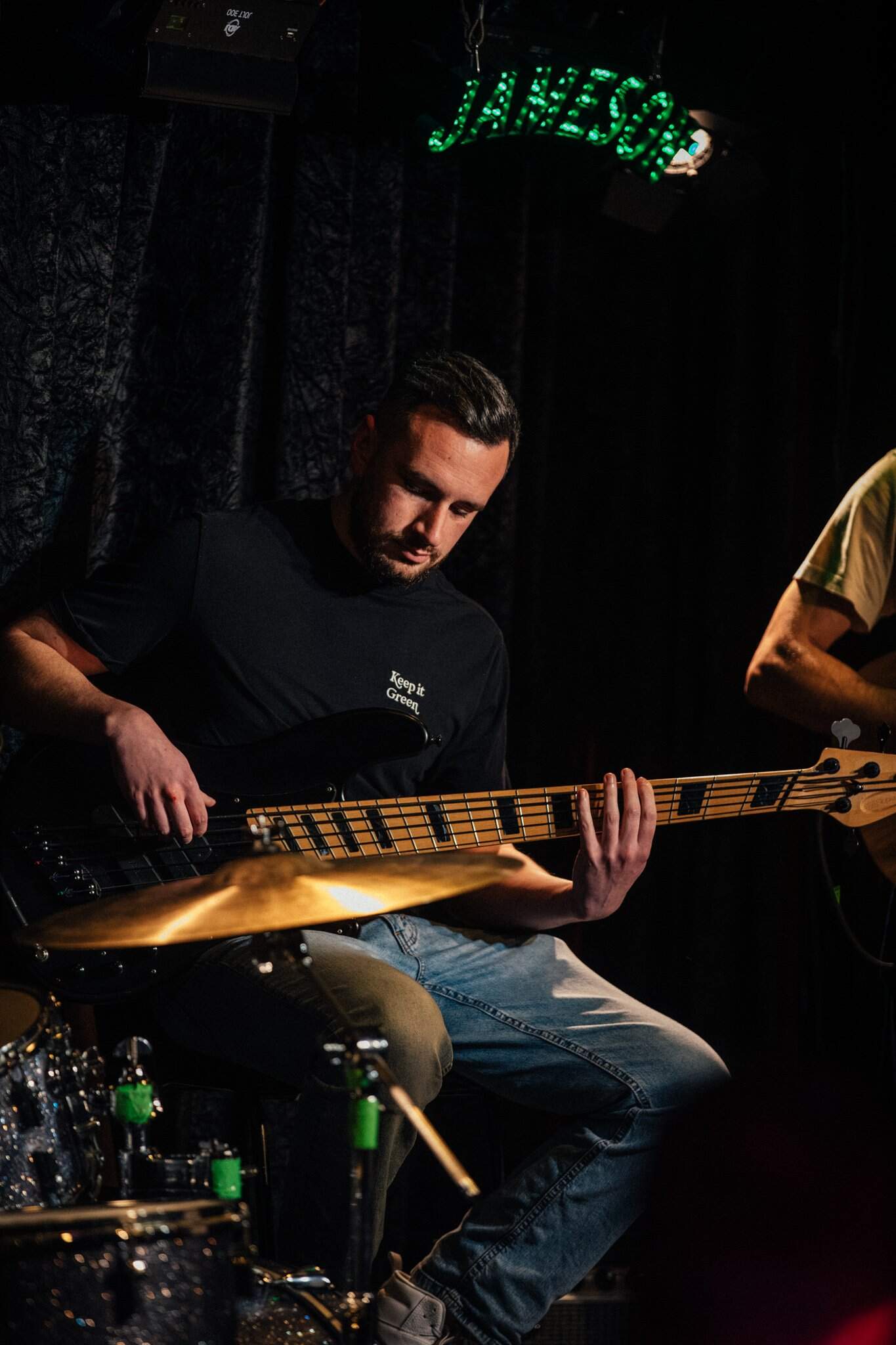 Talented musician playing bass guitar during a live performance at Lavery's, capturing the vibrant atmosphere of the "Kick Out the Jams" event.