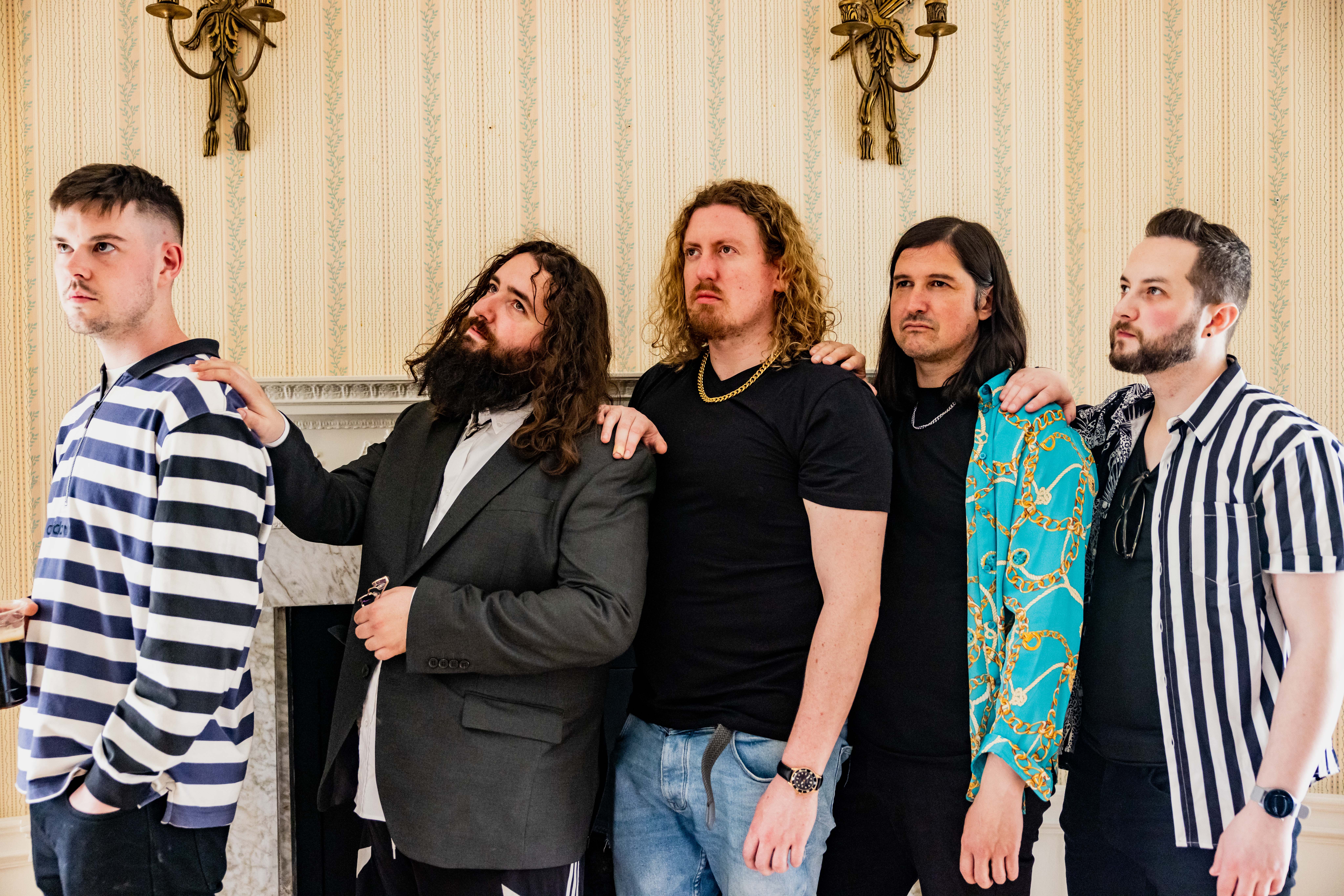 Group photo of Lavery's band members standing indoors, showcasing their diverse styles and personalities.