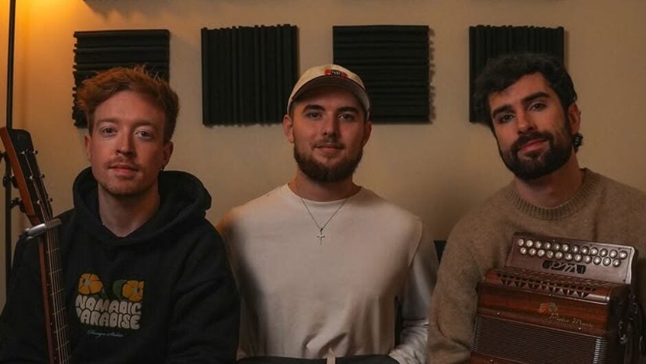 Lavery's band members in a recording studio, posing with musical instruments including a guitar and an accordion, ready for a performance or rehearsal.